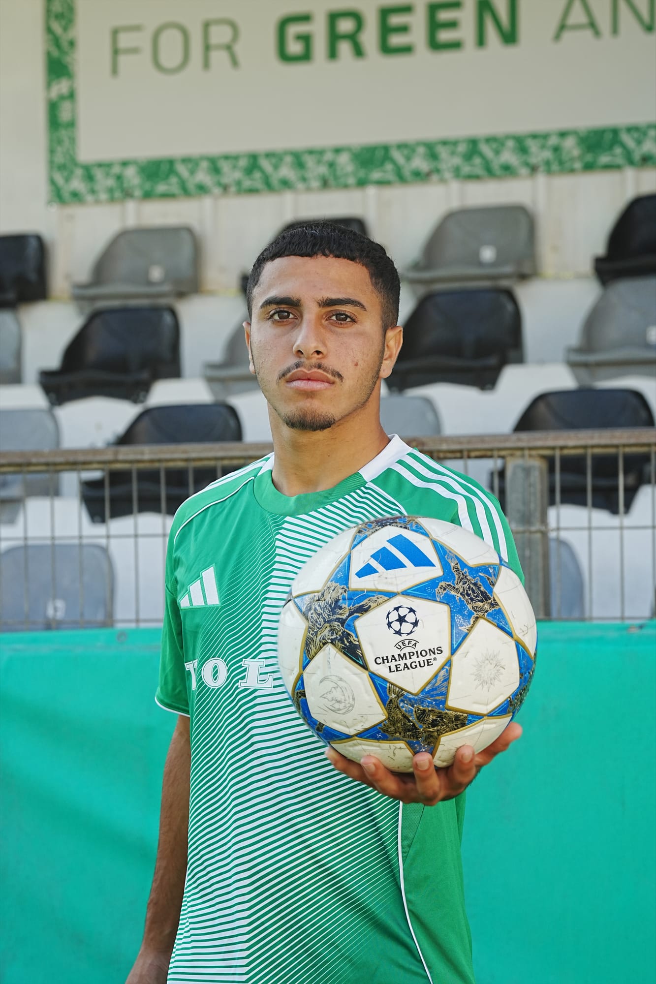 Maccabi Haifa player holding the UEFA Champions League ball