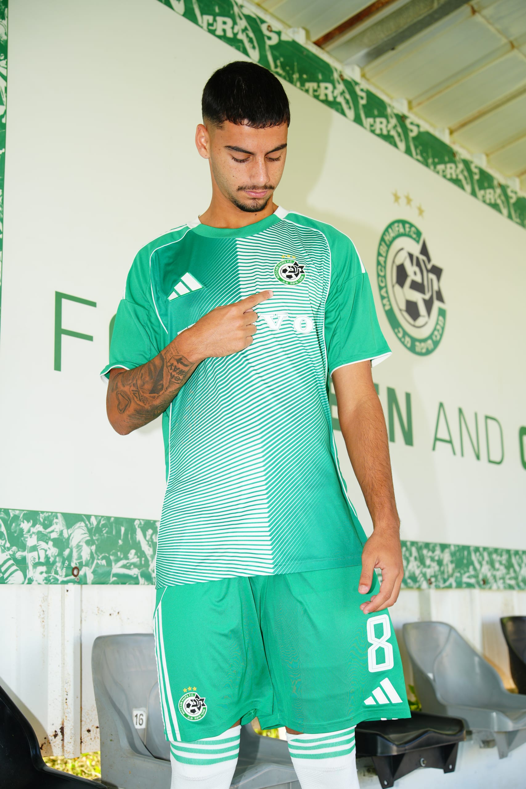 Maccabi Haifa player number 8 pointing to the club badge