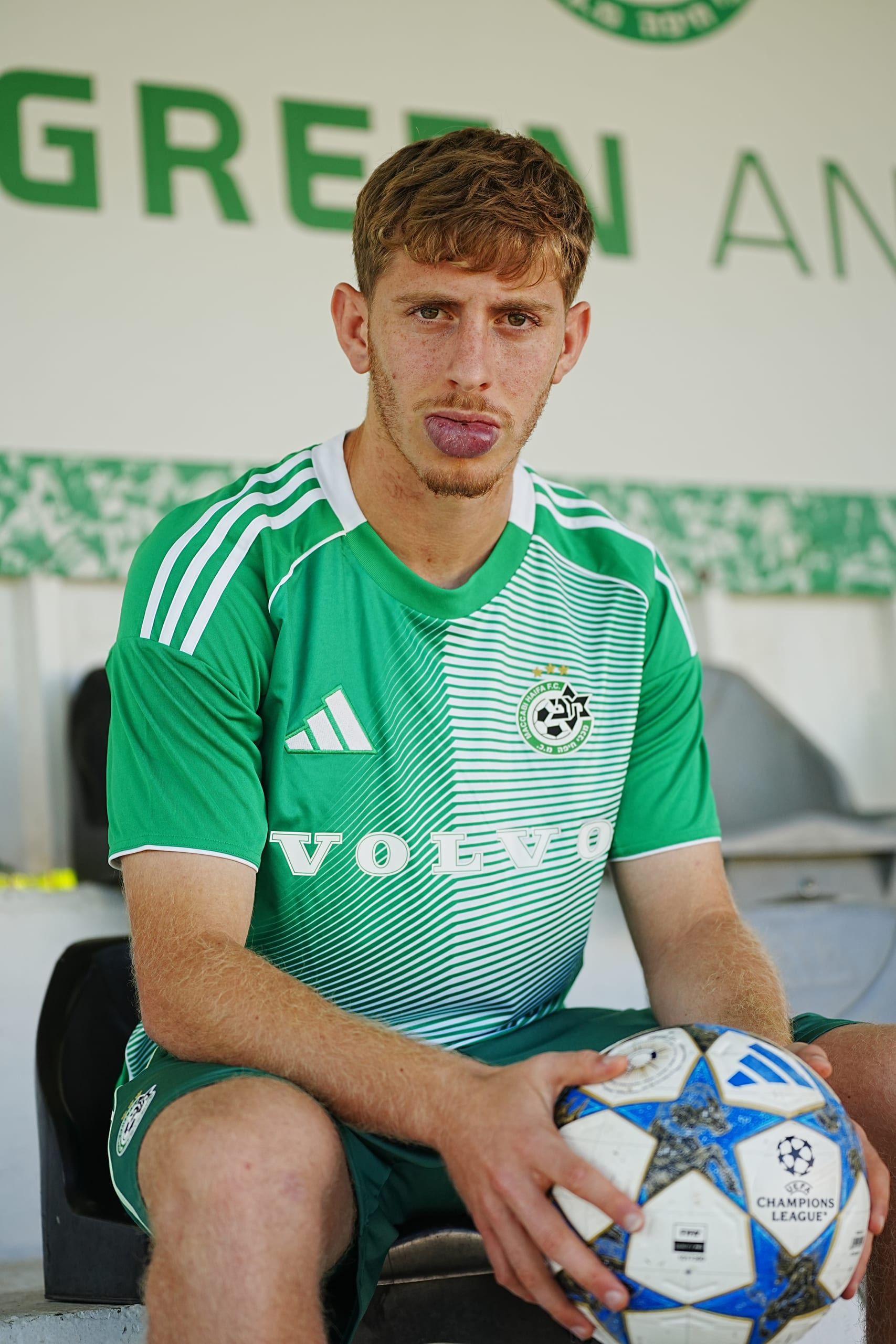 Player on the bench holding the Champions League ball
